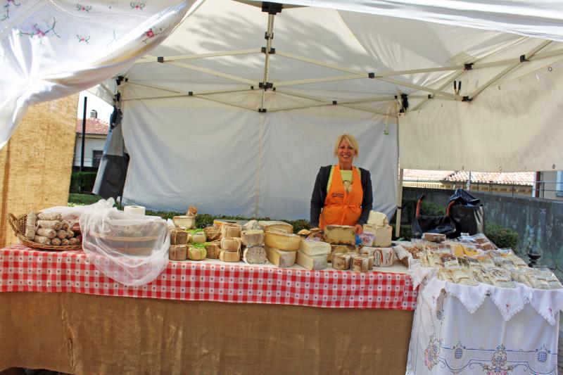 In the farmers market, selling cheese   